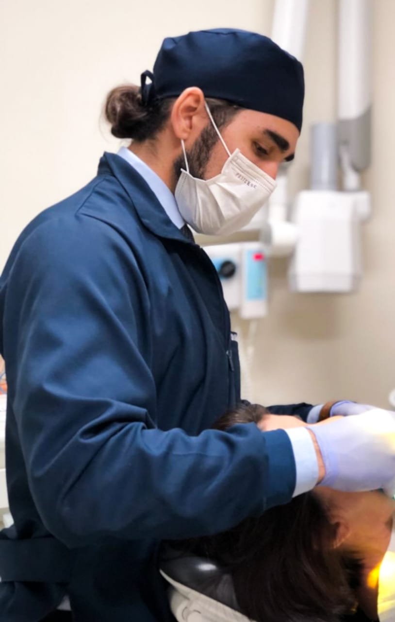 Dentista em Cascavel - PR realizando profilaxia em paciente.